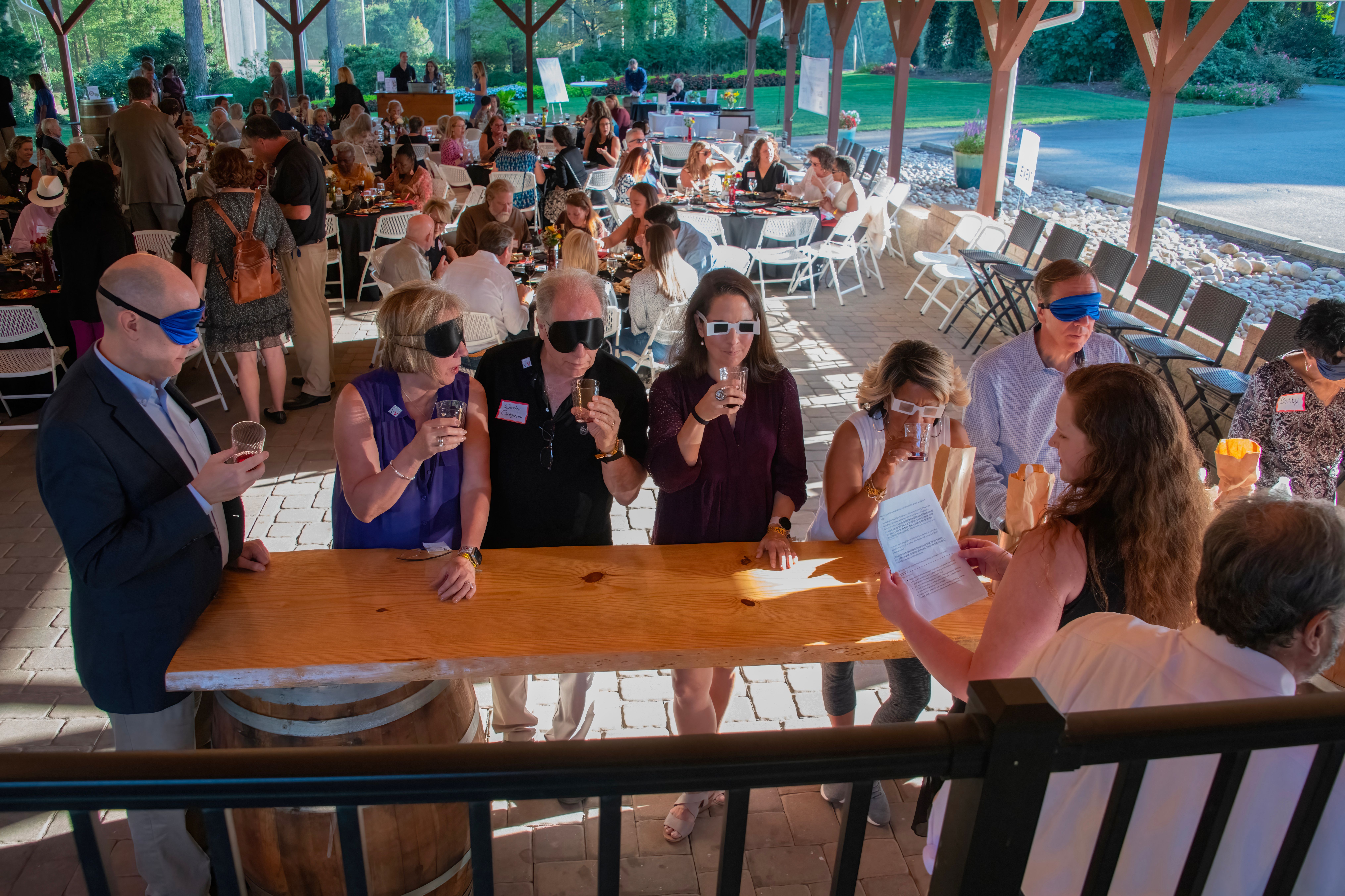 Wine tasting with blindfolds and distortion glasses at 2023 Anniversary Gala